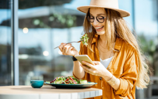 A woman enjoying Astoria Vegetarian Restaurants.
