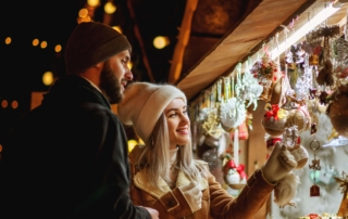 A man and a woman at the Astoria Holiday Market.